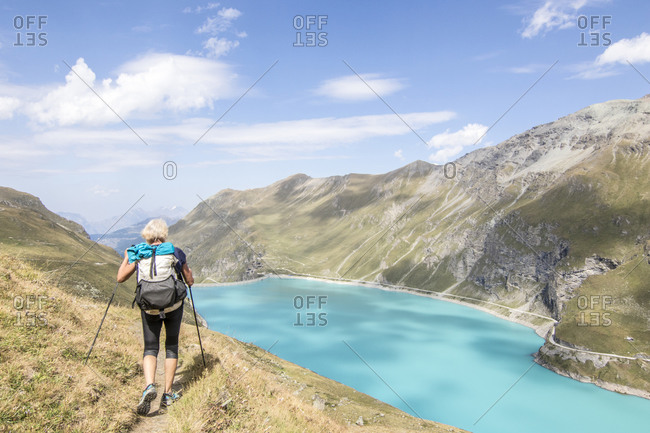 Senior hiker near lake in Swiss Alps, Haute Route Traverse, Valais Canton, Switzerland