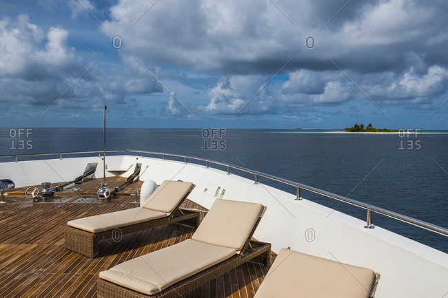 Sun loungers on stern of luxurious yacht, Maldives
