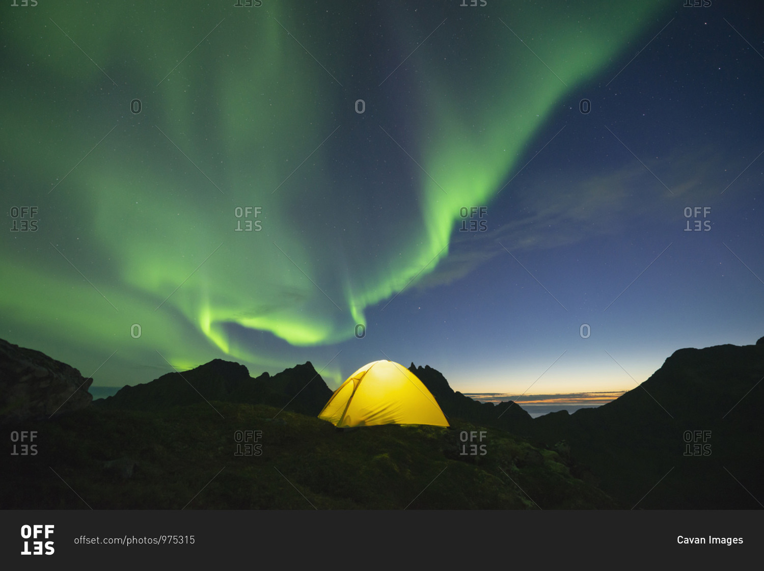 Northern Lights - Aurora Borealis fill sky over yellow tent, Muskiness, Loftin Islands, Norway