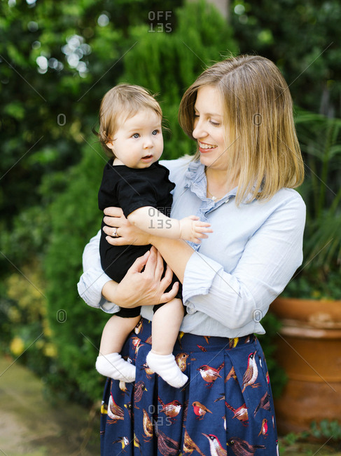 Portrait of mother holding baby daughter (12-17 months)