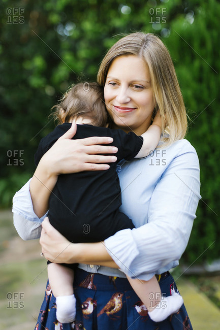 Portrait of mother holding baby daughter (12-17 months)