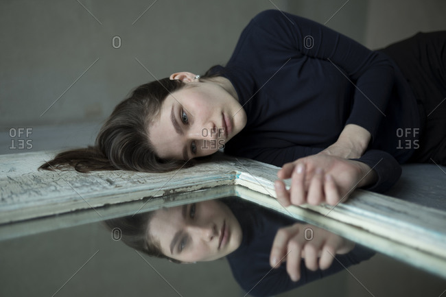 Teenage girl lying by mirror