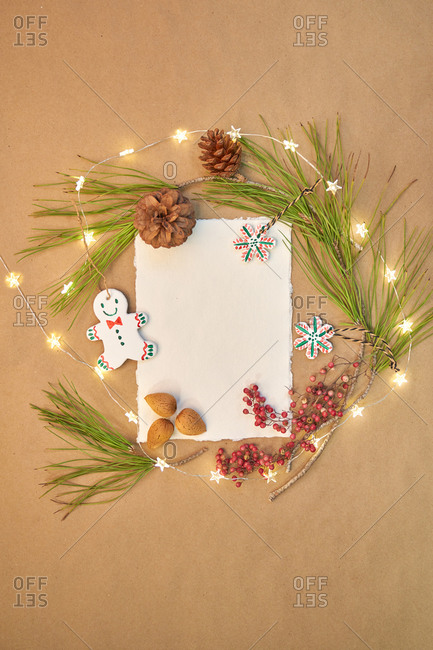 Christmas greeting written with a beautiful handmade letter with Christmas decorations and lights around.