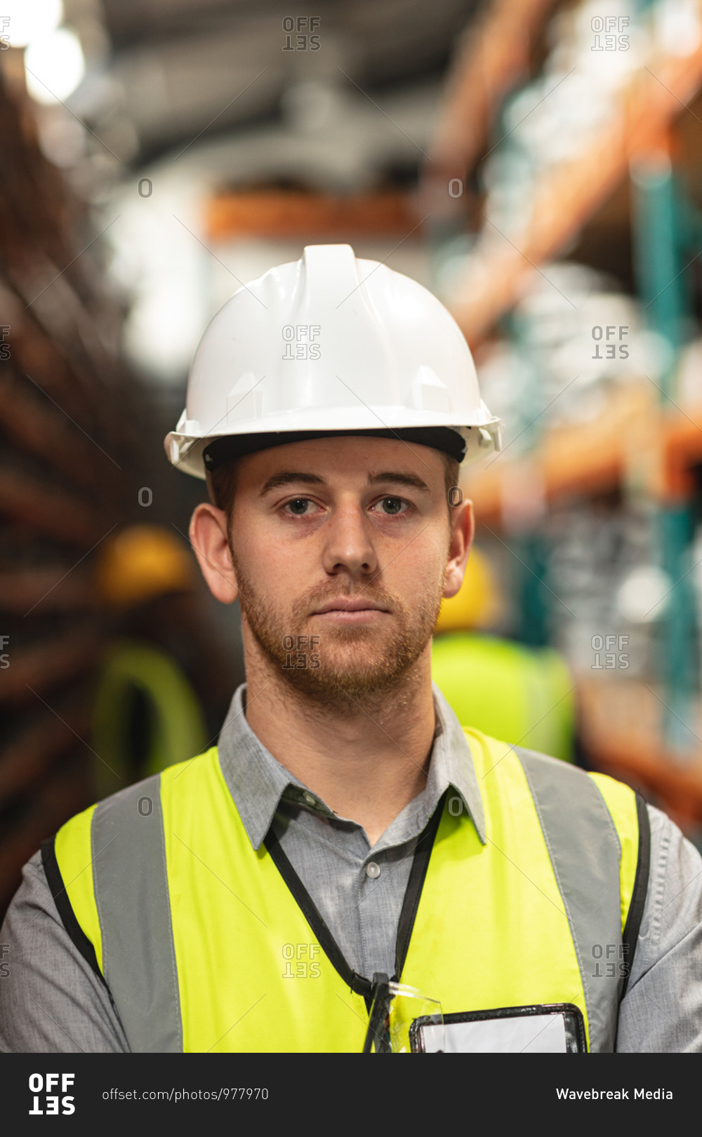 Portrait of a male factory worker wearing a Hi-vis vest and safety helmet