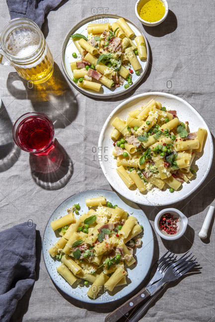 Italian recipe Pasta tortilloni with green pea, mint leaves smoked bacon and cheese.