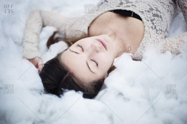 Young woman lies on cotton balls