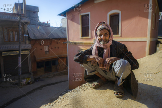 February 7, 2014: Nepalese man in typical sitting pose, Tansen, Nepal