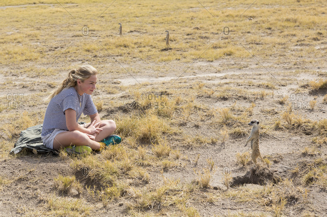 Twelve year old girl looking at Meerkats, Kalahari Desert, Makgadikgadi Salt Pans, Botswana