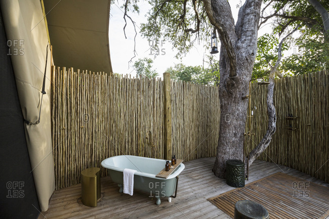 A outdoor bath tub in a tented safari camp