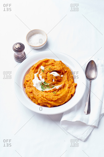 Roast sweet potato, squash and garlic mash served with cream and thyme