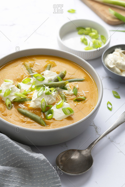Pumpkin and green bean soup served with sour cream, spring onions and shredded coconut.