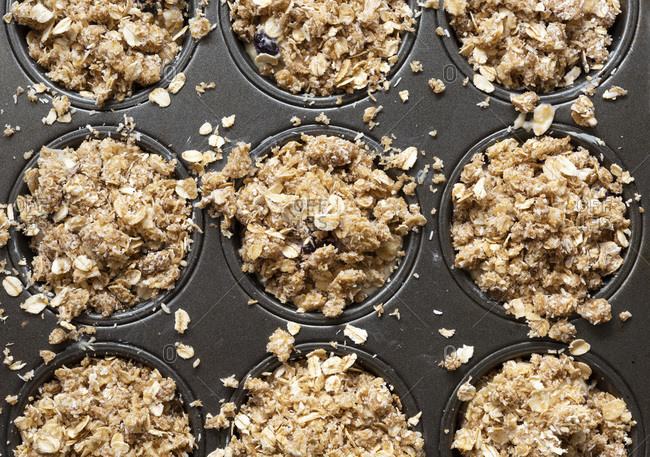 Closeup view of blueberry muffins with oat crumble topping.