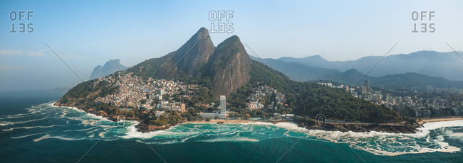 Aerial Panoramic View Of Two Brothers Mountain And Vidigal Favela With Tropical Ocean Waves Breaking Along The Coastline In Rio De Janeiro, Brazil