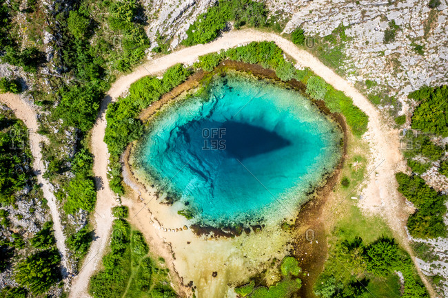 Aerial view of a small lake with turquoise water in Cetina, Croatia