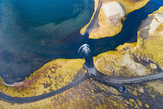 Abstract aerial view of a car fording a stream of water at a 4WD road, Veidivotn, Iceland