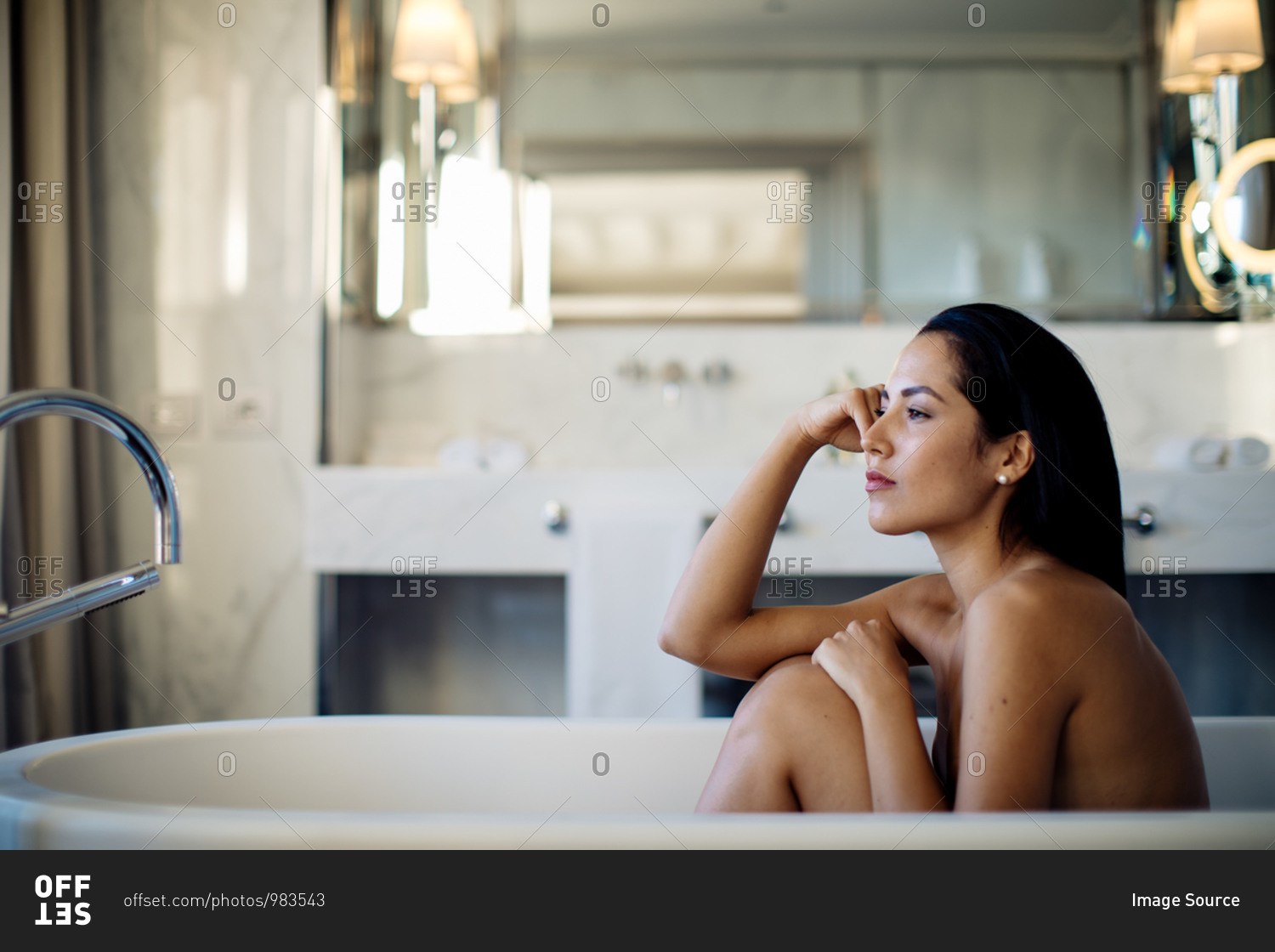 Woman relaxing in bathtub in suite
