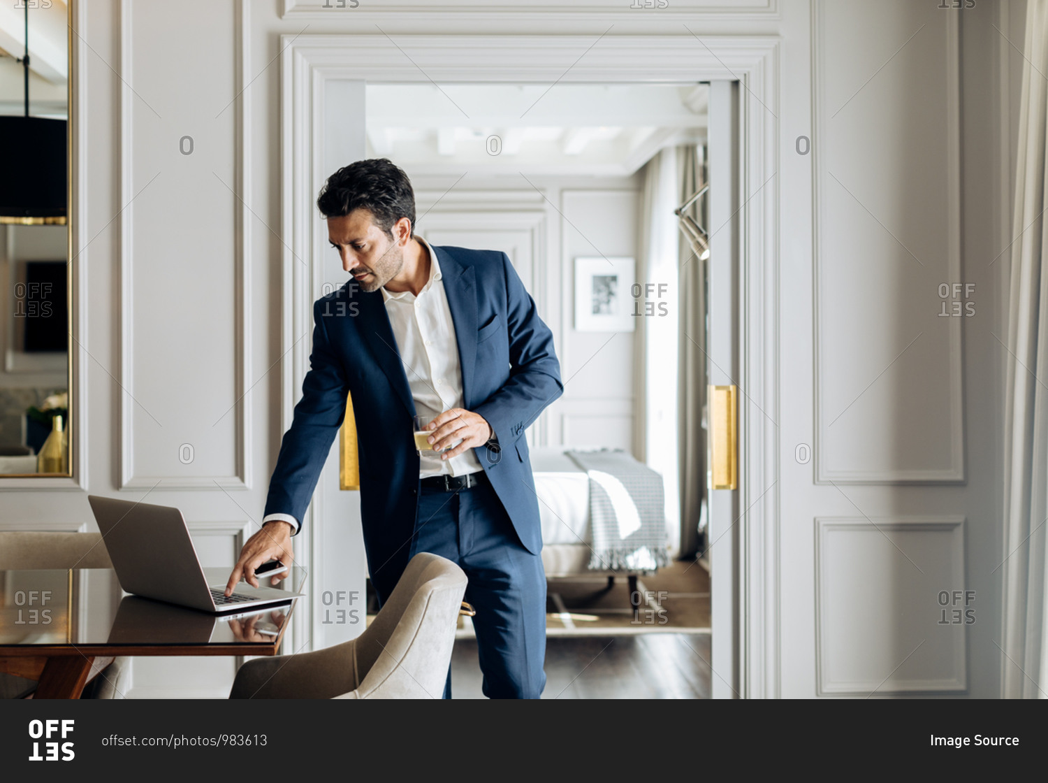 Businessman using laptop in suite