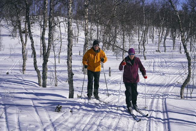 Couple cross-country skiing in Vasterbottens Lan, Sweden.