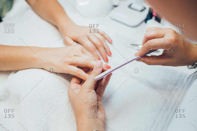 Woman getting a manicure in a beauty salon.