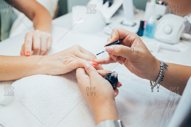 Woman getting a manicure in a beauty salon.
