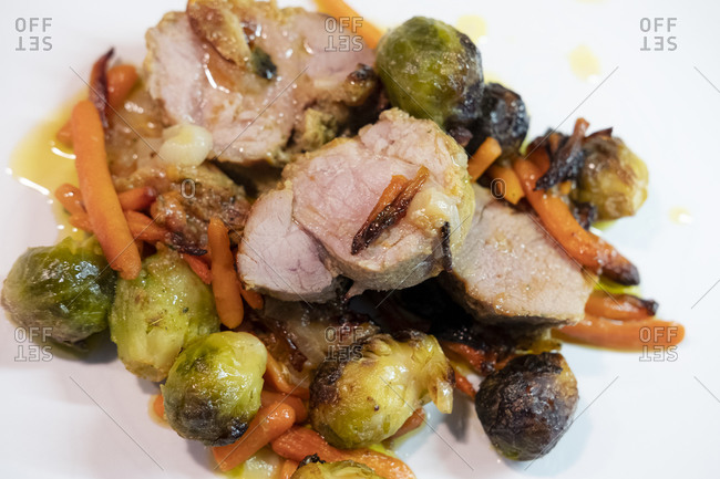 Pork loin with honey and mustard with carrots, onions and Brussel sprouts