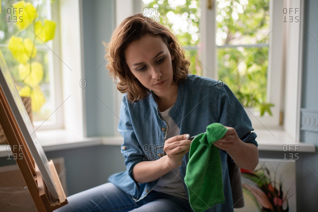 Woman Cleaning The Window Sill In Office Stock Photo - Download