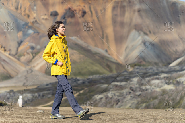 Young woman is admiring Iceland's foreign volcanic landscape