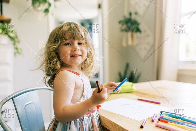 Little toddler girl drawing at home