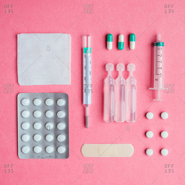 Still life of medical supplies on pink background