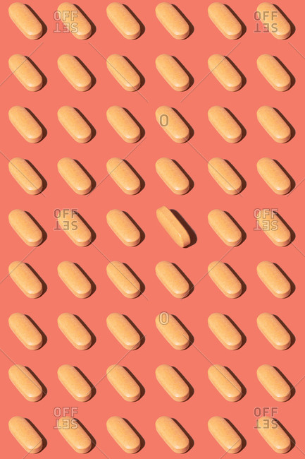 Pattern of Yellow Pills on pink yellow background