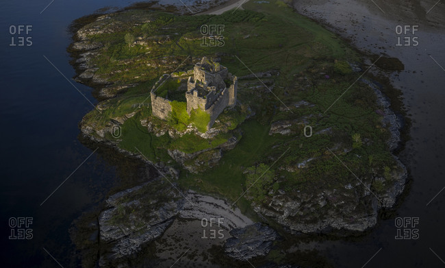 Aerial drone shot of Castle Tioram, it is a ruined castle in Scotland