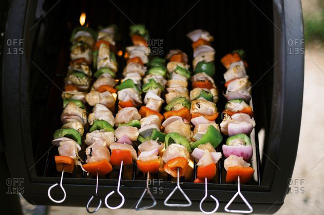 Colorful chicken skewers on the grill.