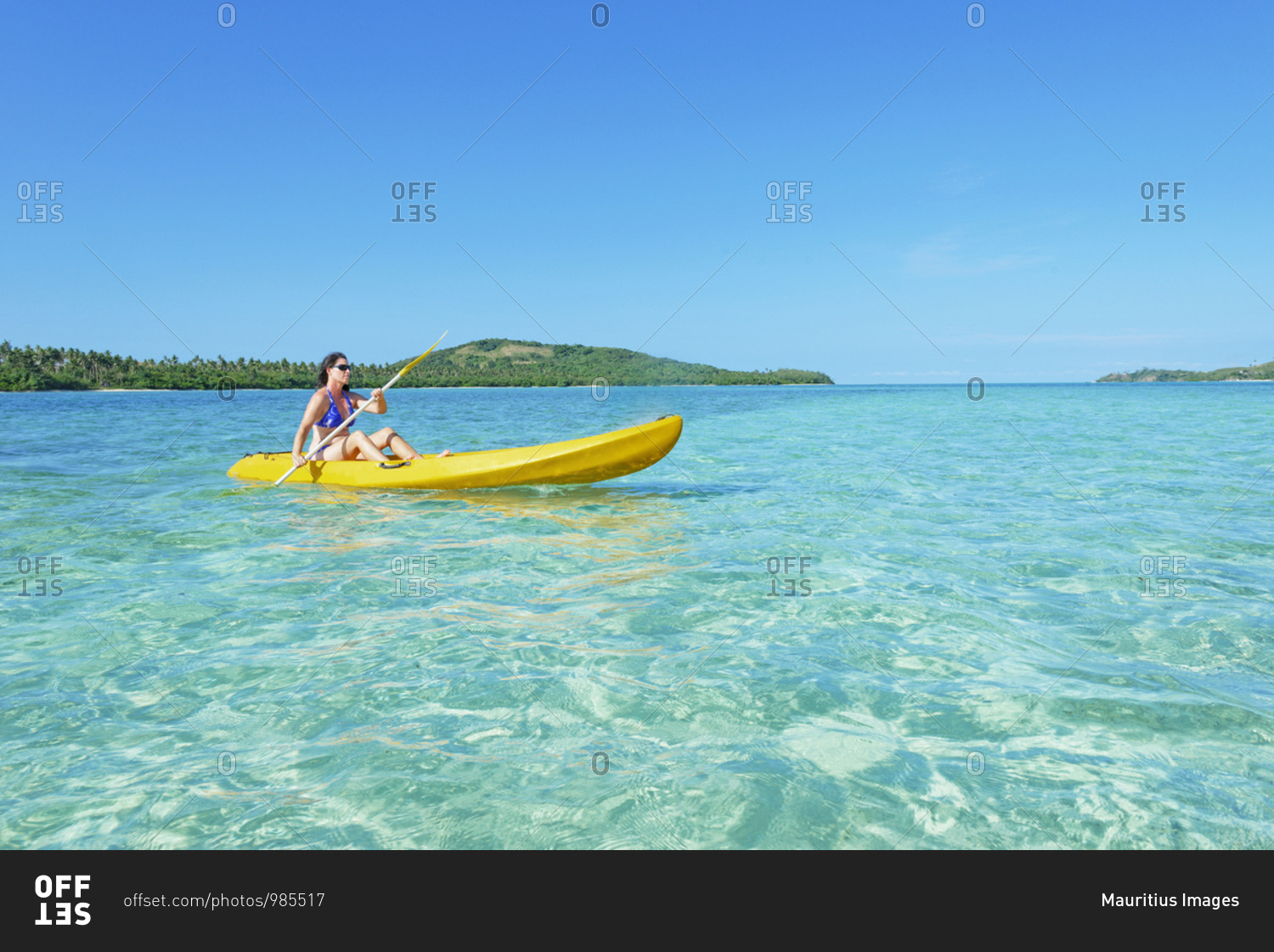 Woman sea kayaking in Fiji turquoise water, Matacawalevu Island, Fiji, South Pacific islands
