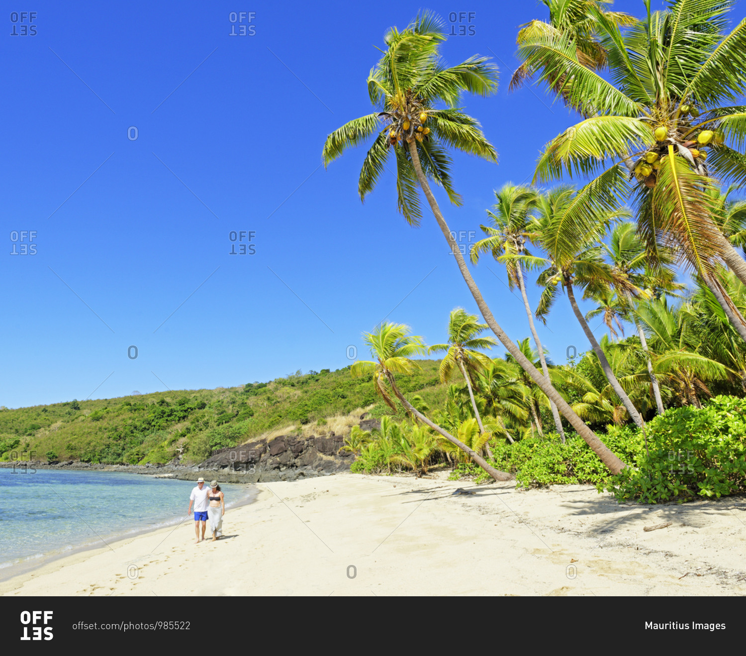 Couple walking on a tropical beach, Drawaqa Island, Yasawa island group, Fiji, South Pacific islands