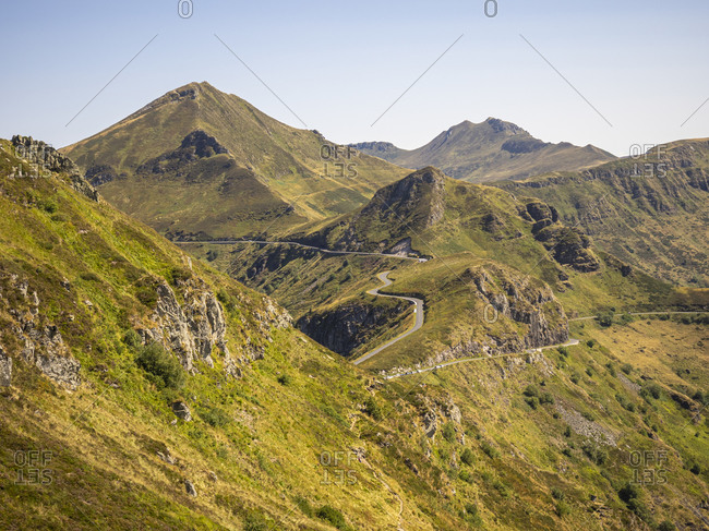 Trekking in the Cantal on the GR 400, volcanic mountains in France, narrow path on the Puy Chavaroche.