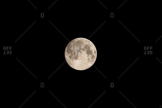 Beautiful full moon in the black nighttime sky