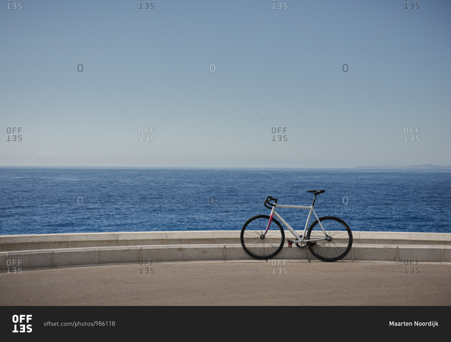 The waters of the Mediterranean sea and a bike resting on the promenade in the city of Nice on the d'Azur in France.