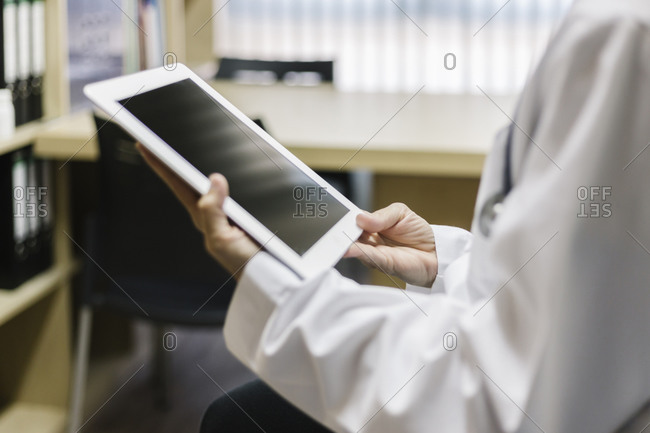 Female doctor holding digital tablet at doctor's office