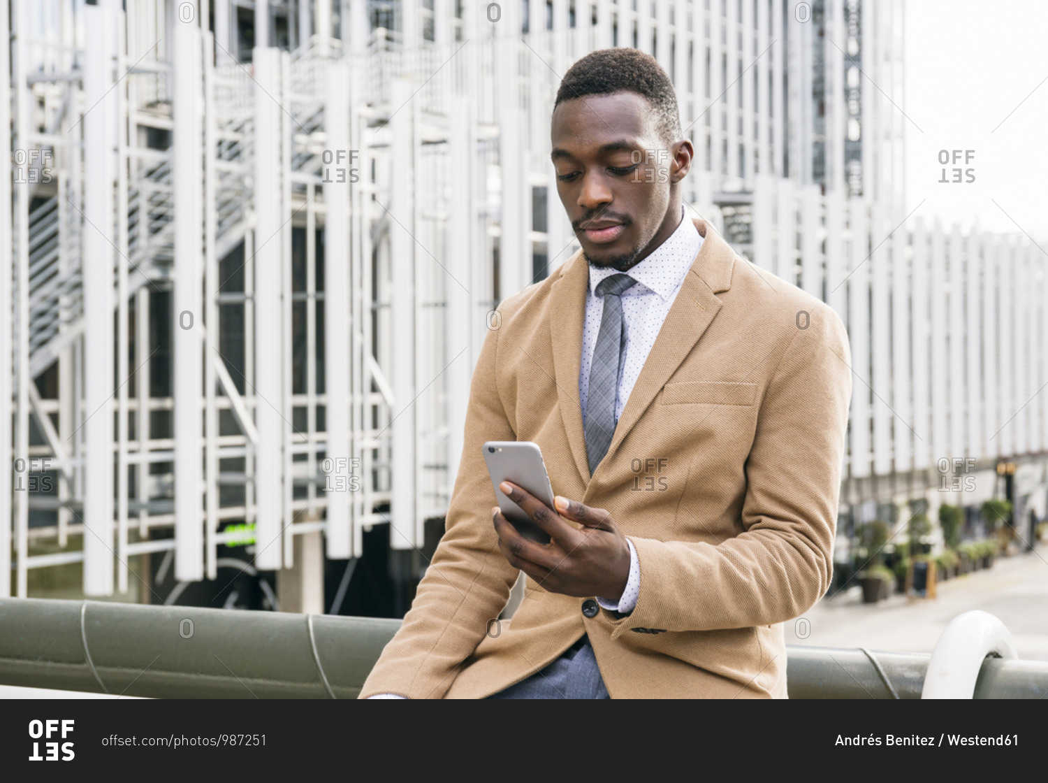 Young businessman using smartphone in the city