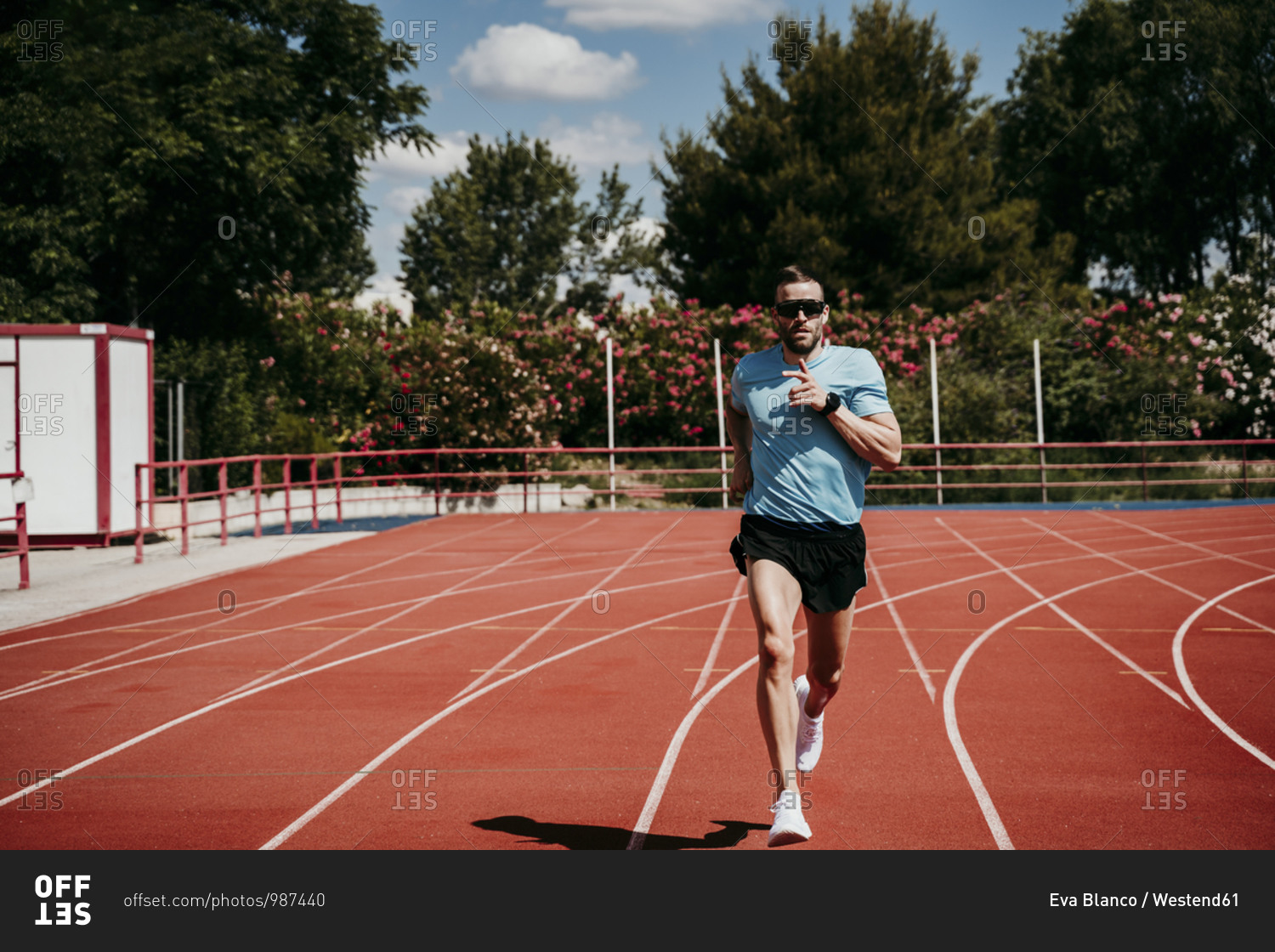 Male athlete running on tartan track