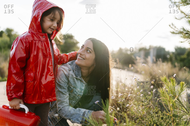 Mother and daughter picking wild flowers
