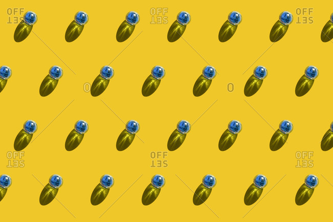 Pattern of blue marbles against yellow background