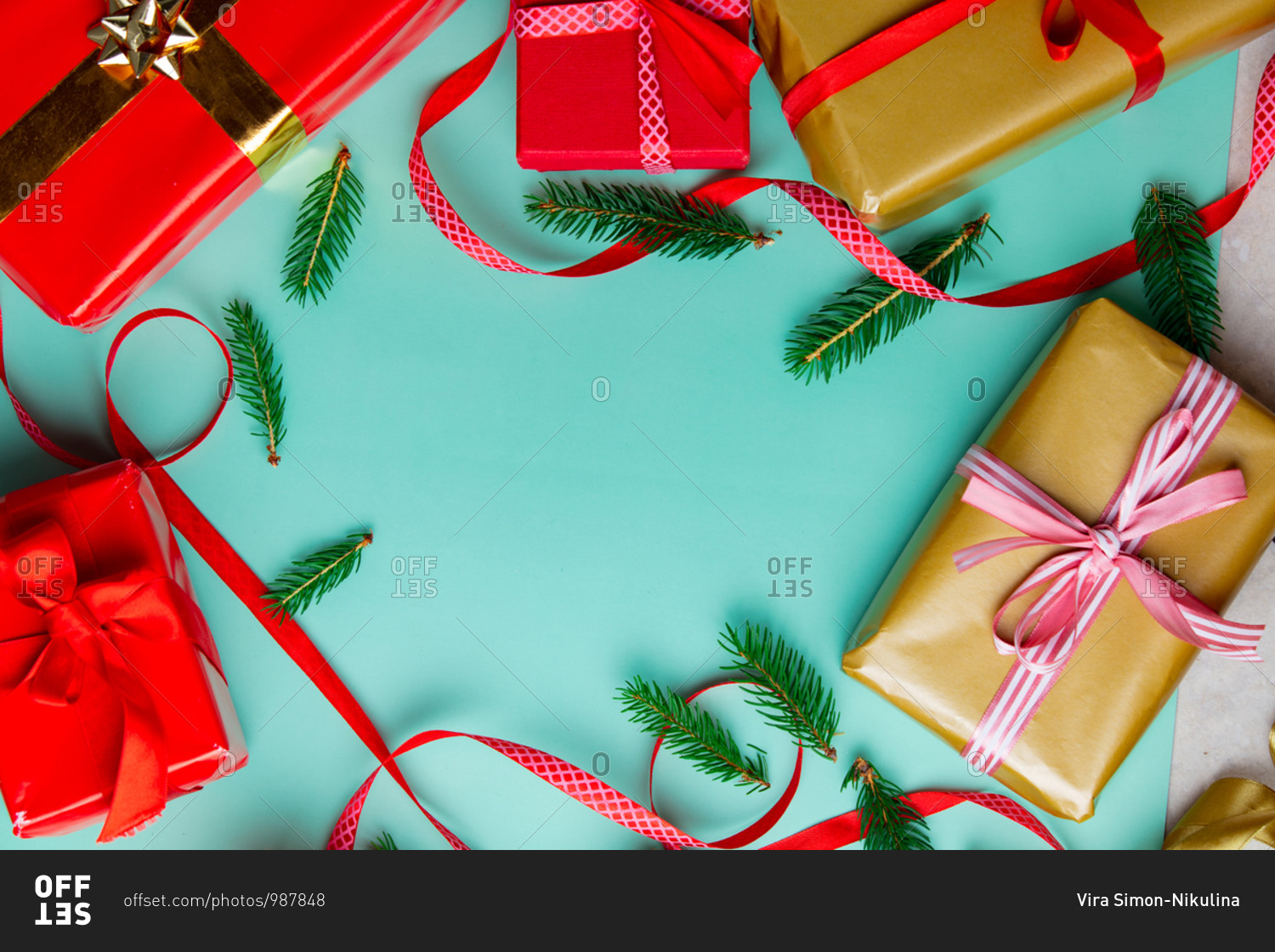 Christmas gifts with ribbons and pine tree branches on blue background