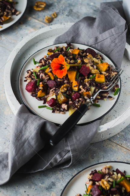 Overhead view of autumnal salad with roasted pumpkin, beets, walnuts, rice and cheese