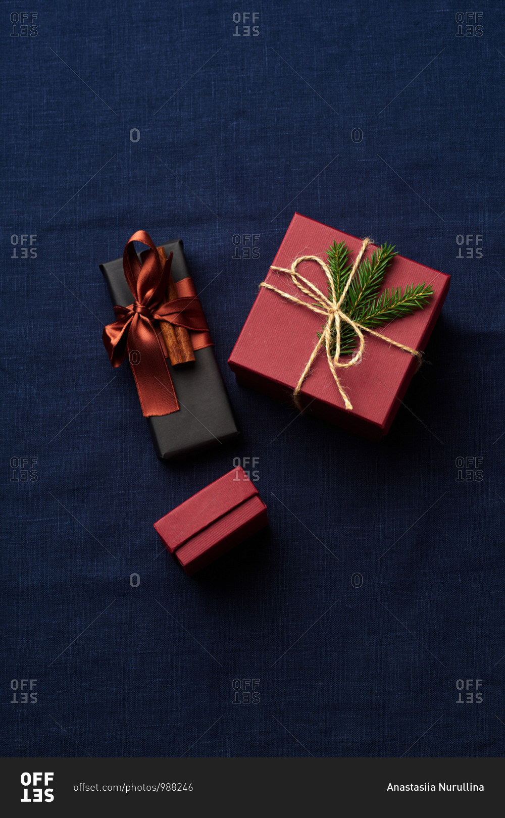 Top view of wrapped and decorated gifts and boxes with presents on blue textile background