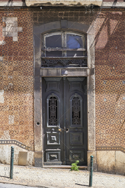 Old building with brown Moorish tiles in the Lapa neighborhood, Lisbon, Portugal