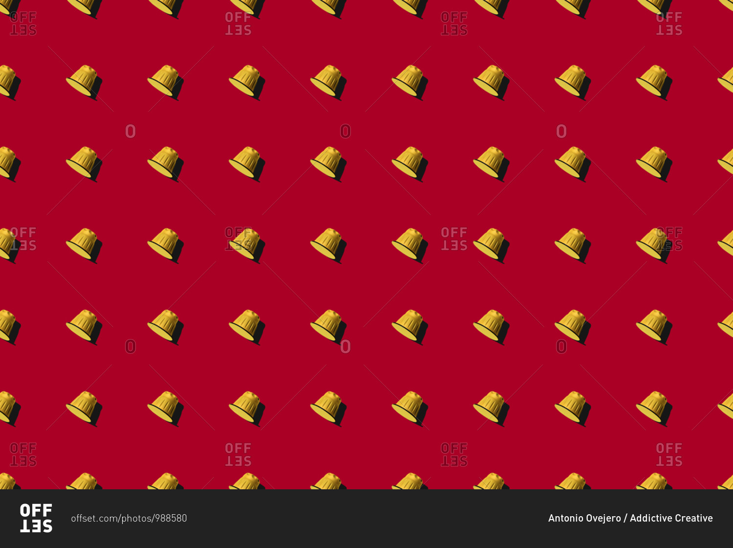 Top view of yellow coffee pods placed in even rows as seamless pattern on red background