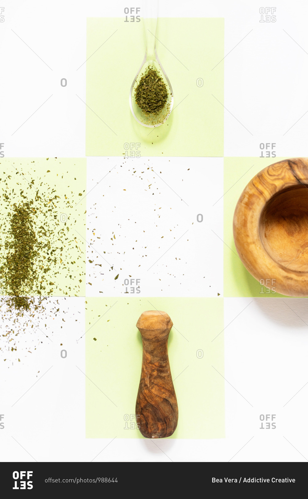 Top view of wooden mortar with pounder near spilled pepper and spiky dry anise with thin golden oat spike