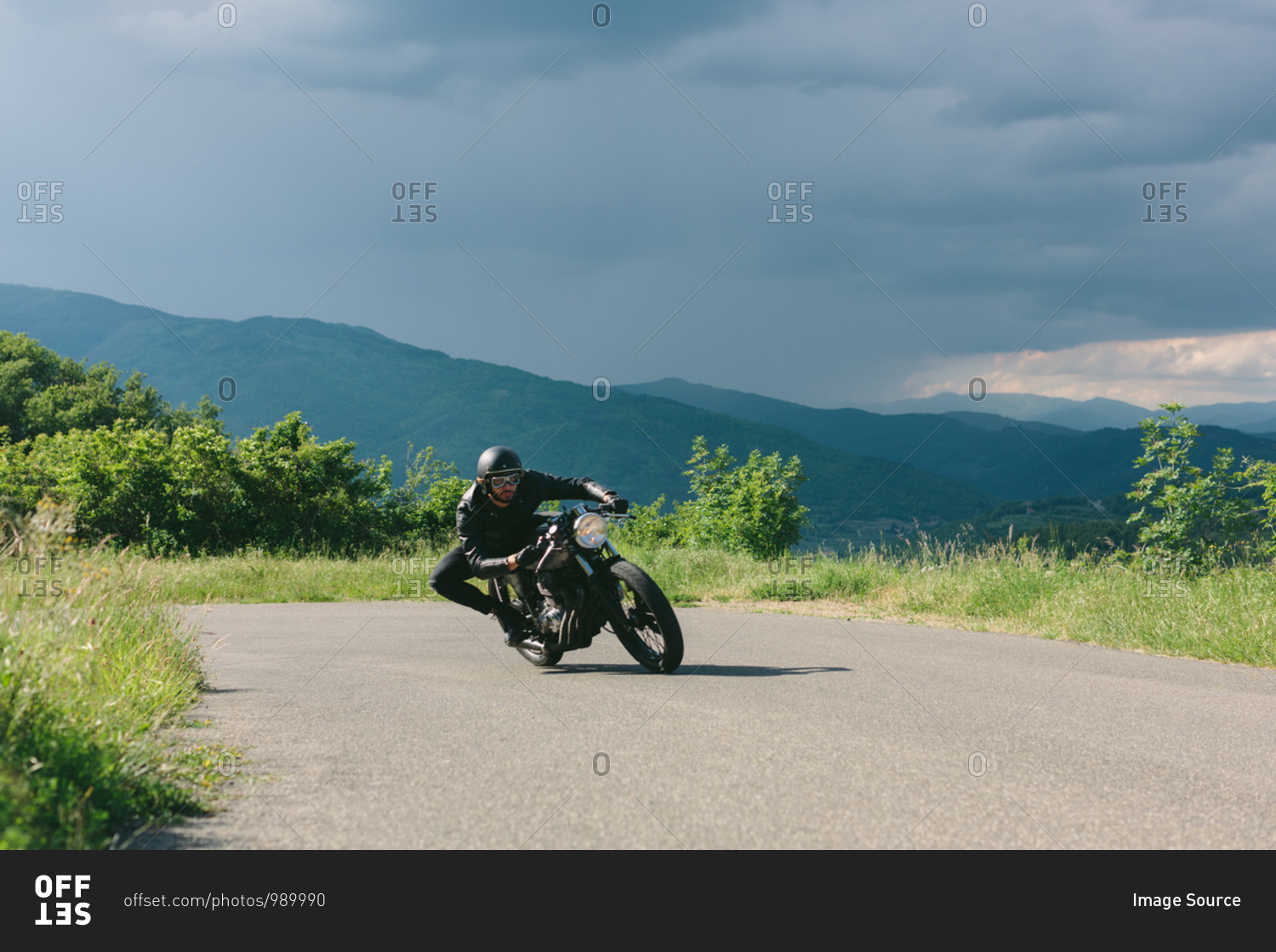Young male motorcyclist on vintage motorcycle swerving
around rural road bend, Florence, Tuscany, Italy stock photo -
OFFSET