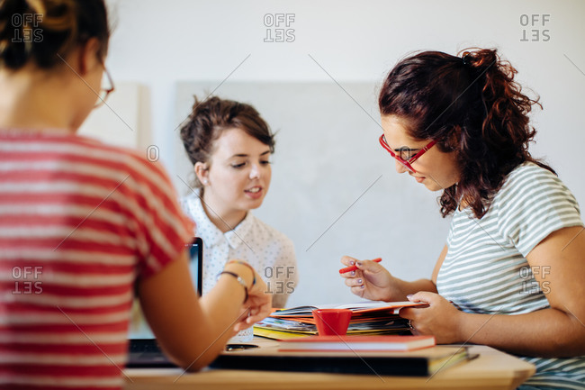 Female colleagues discussing documents together